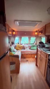 Interior view of a small, cozy caravan.