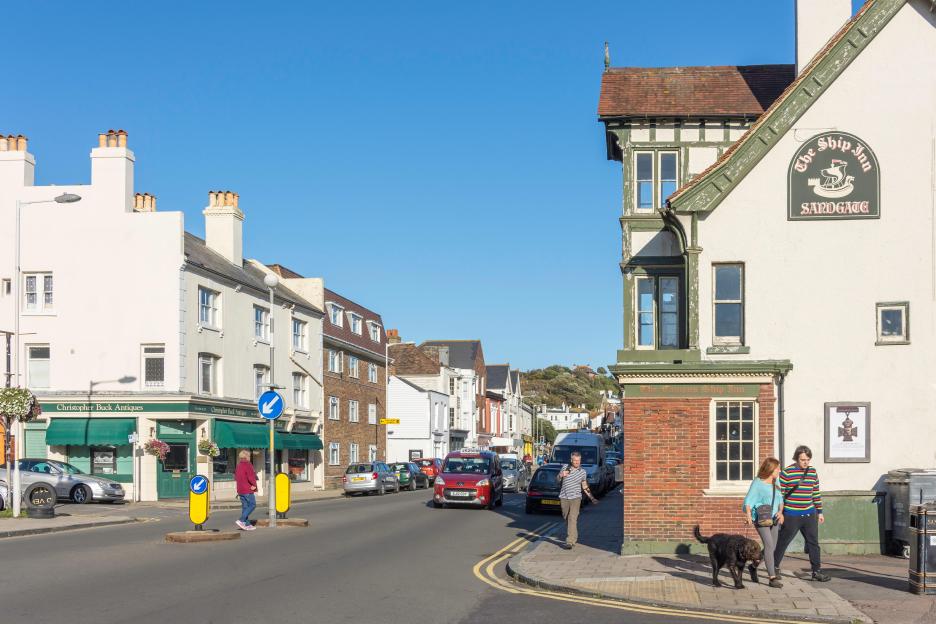 High street in Sandgate, Kent, with pedestrians and cars.