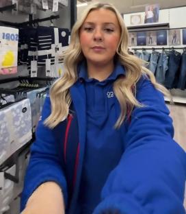 Tesco employee showing summer clothing.