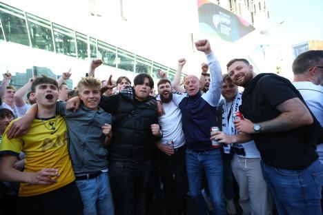 Group of excited Tottenham Hotspur fans outside the stadium.
