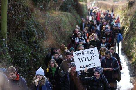 Protestors marching with signs advocating for wild camping.