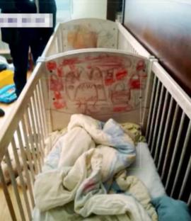 Child's crib with drawings on the side.