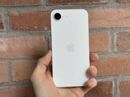 White iPhone held in hand.