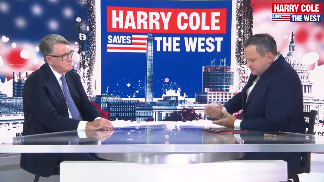 Two men sitting at a table discussing "Harry Cole Saves the West."