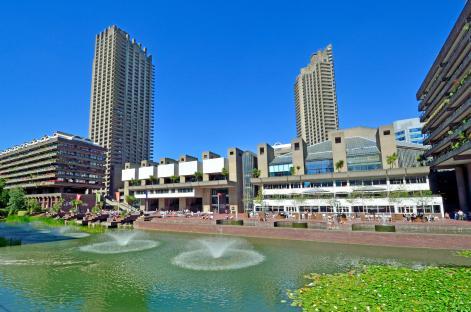 The Barbican Centre in London, featuring its architecture and a reflecting pool.