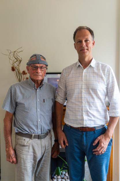 Photo of Dr. George Stothart and volunteer John Stennard; John is wearing a device to test brainwave activity.