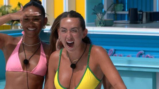 Two women in bikinis reacting excitedly.