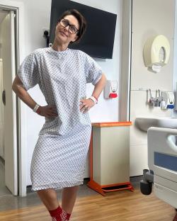 Woman in hospital gown and red socks.