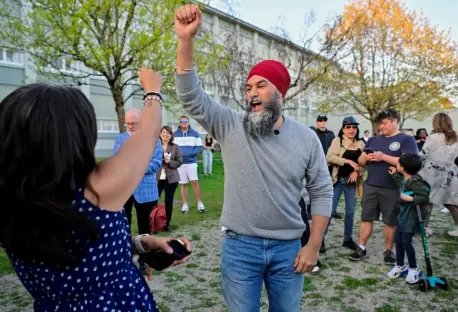 Man in red turban celebrating with a woman.
