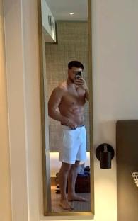 Man taking a mirror selfie in a hotel room.