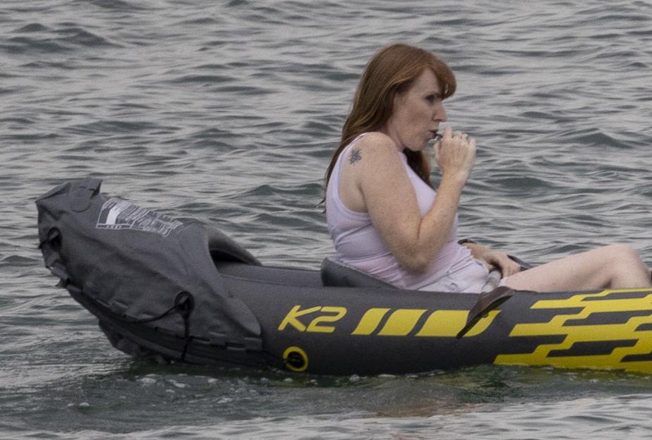 Angela Rayner and a child in a small inflatable boat on the water.