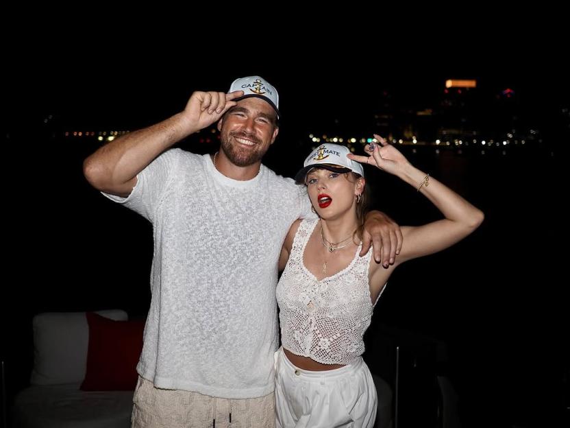 Taylor Swift and Travis Kelce wearing captain's hats.