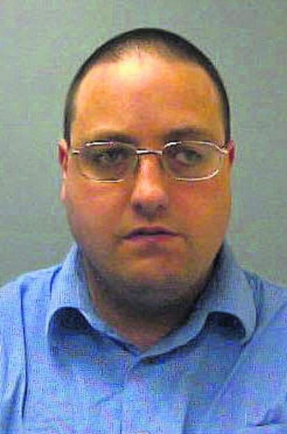 Mugshot of Marcia Walker, a light-skinned individual with closely cropped dark hair and glasses, wearing a blue collared shirt.