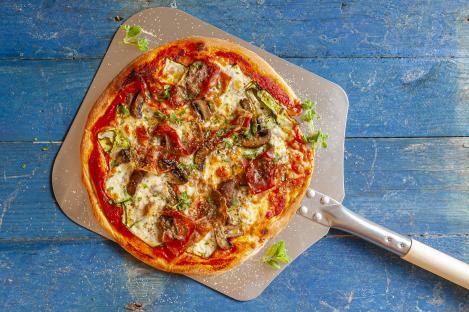 Aerial view of pizza on a peel.