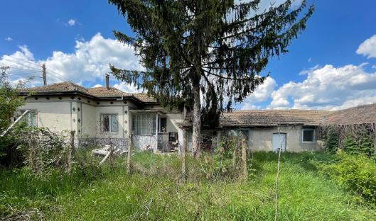 A three-bedroom house in overgrown grass.
