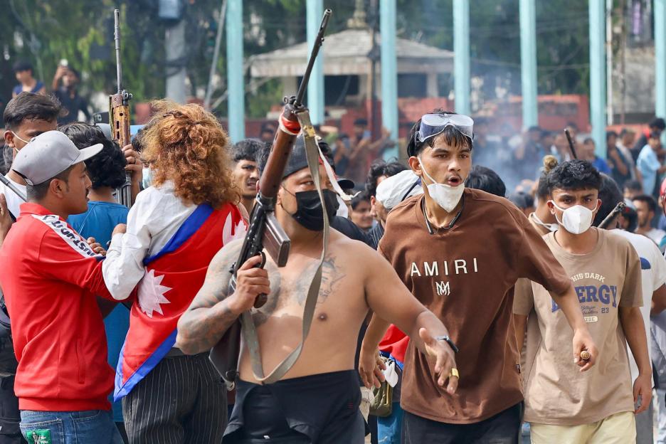 Protester carrying a firearm at a demonstration in Kathmandu.