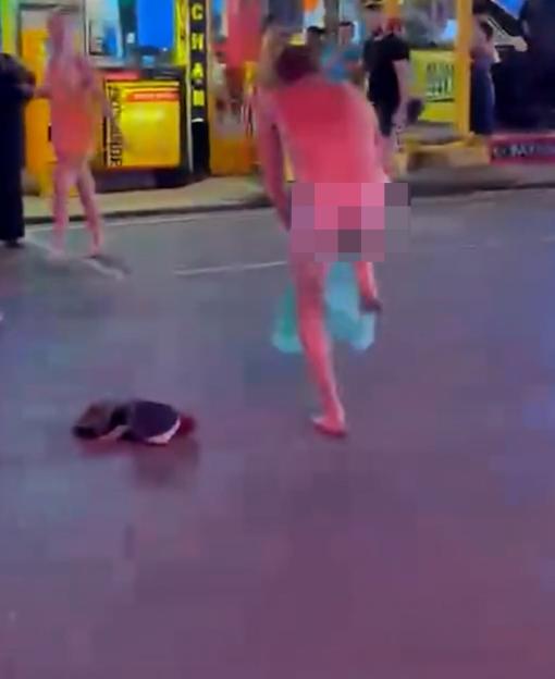 A British tourist dancing naked in a red-light district.