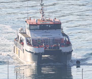 Boat carrying migrants into port.