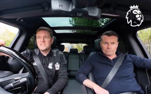 Two men sitting in the front seats of a car.
