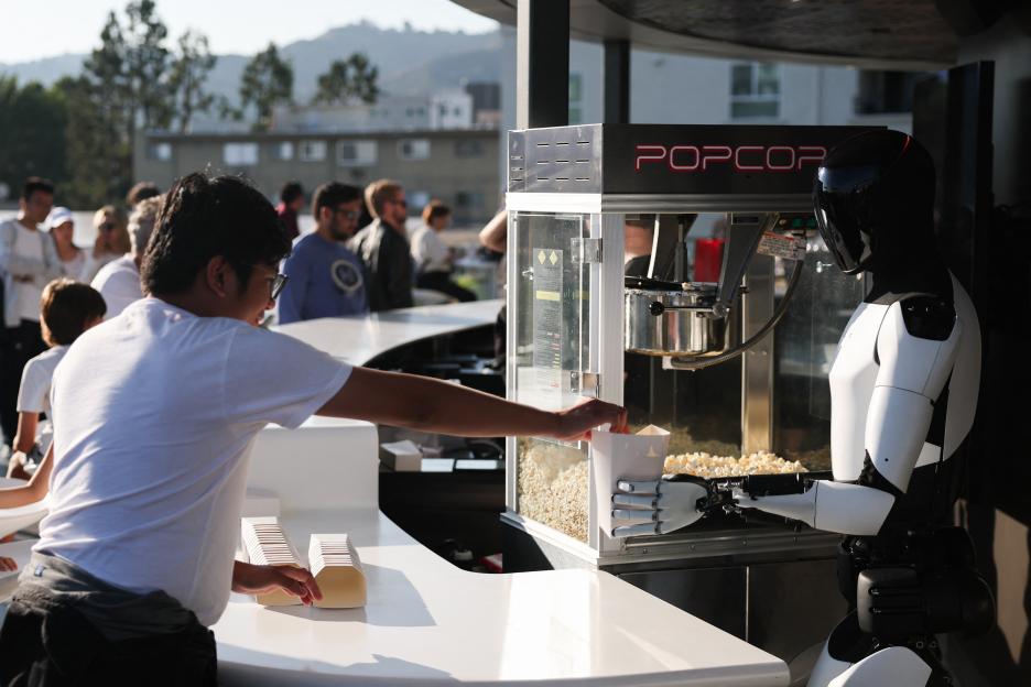 Tesla Optimus robot serving popcorn.
