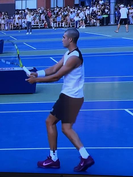 Tennis player preparing to serve.