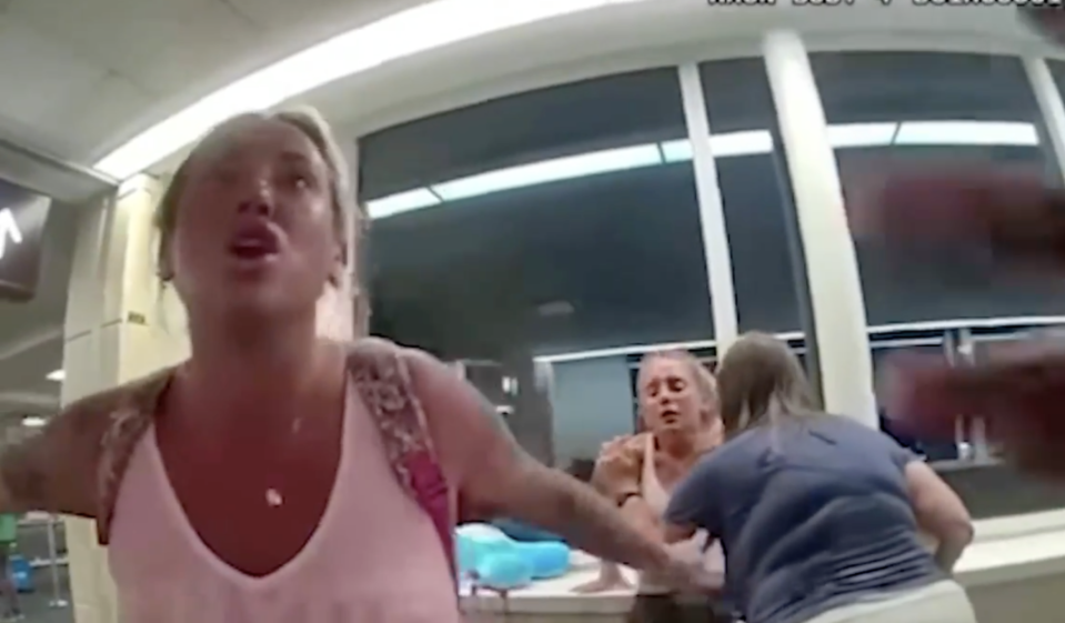Woman yelling with two other women in the background.