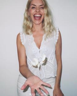 Holly Willoughby holding out her hand with Wyldemoon products falling towards it.