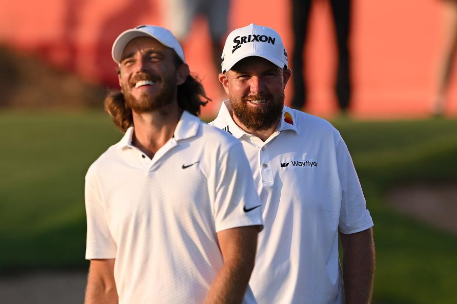 Shane Lowry and Tommy Fleetwood smiling on the 18th green.