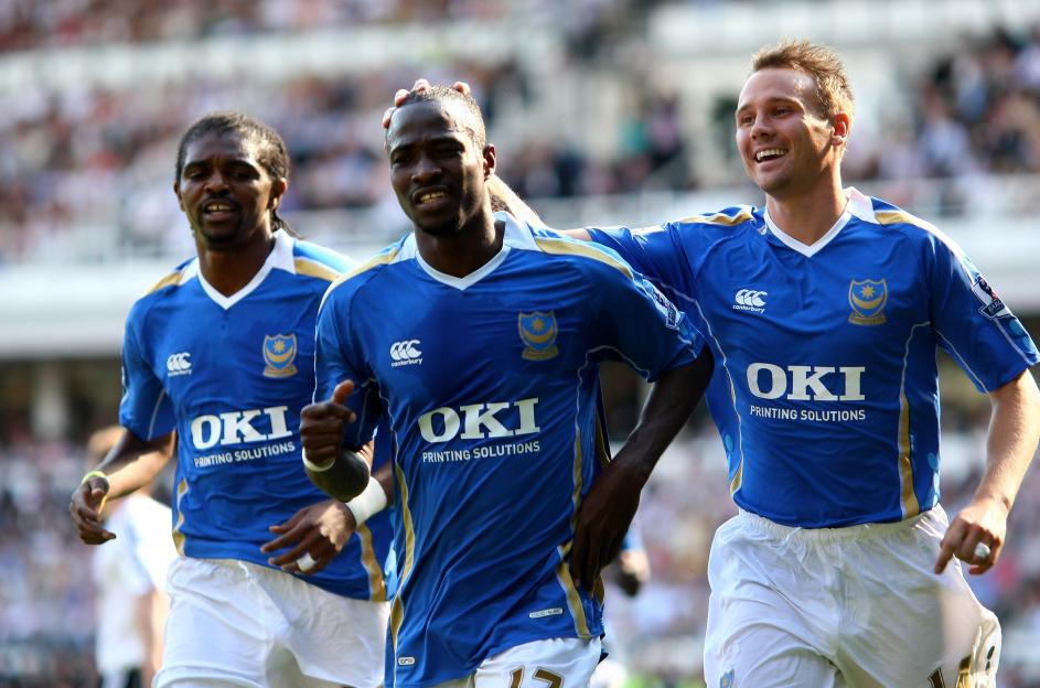 Portsmouth soccer players celebrating a goal.