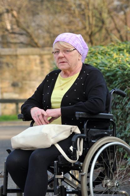 Woman in wheelchair at a charity event.