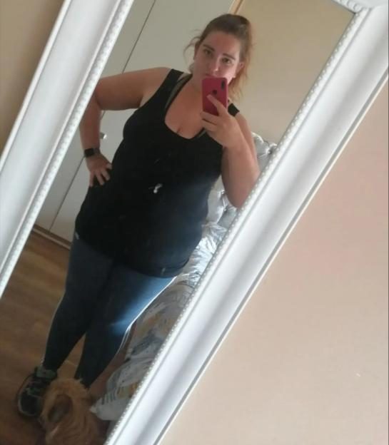 Woman taking a selfie in a mirror.