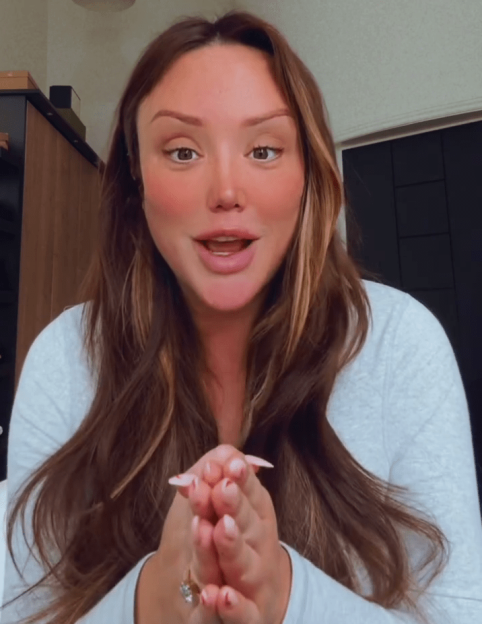 Charlotte Crosby speaking to the camera with hands clasped together.