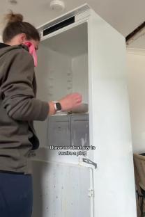 Person cleaning a dirty fridge.