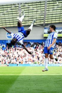 Carlos Baleba of Brighton celebrates a goal with a backflip.