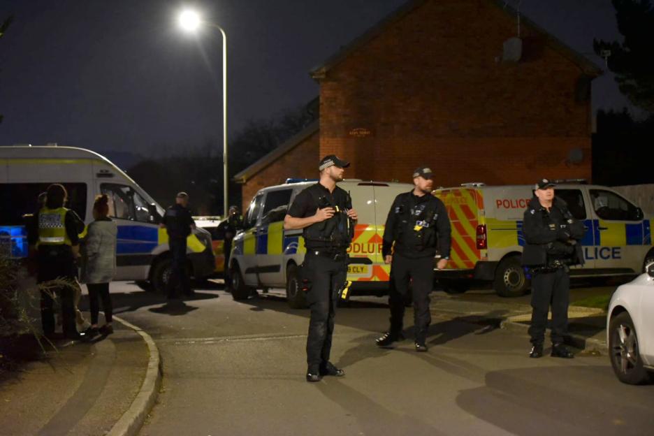 Police and emergency services at a murder scene.