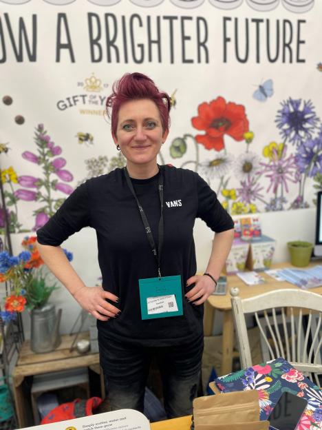 Emily Atlee, Seedball Co-Founder & Head of Sales, at a trade show.
