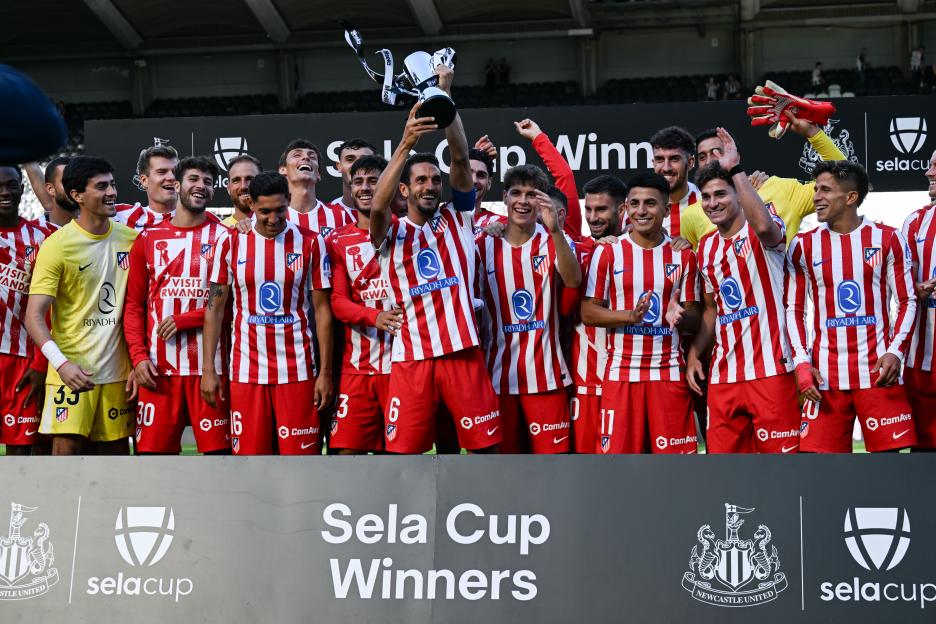 Atletico Madrid players celebrating Sela Cup victory.