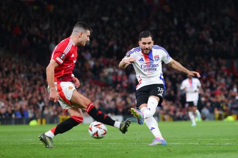 Rayan Cherki of Olympique Lyonnais scoring a goal during a soccer match.