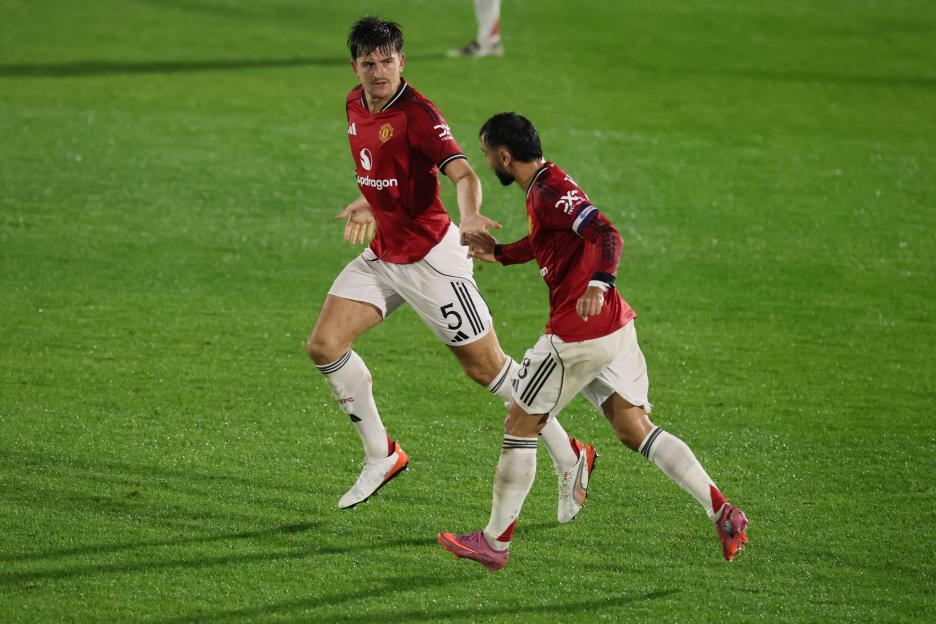 Two Manchester United soccer players celebrating a goal.