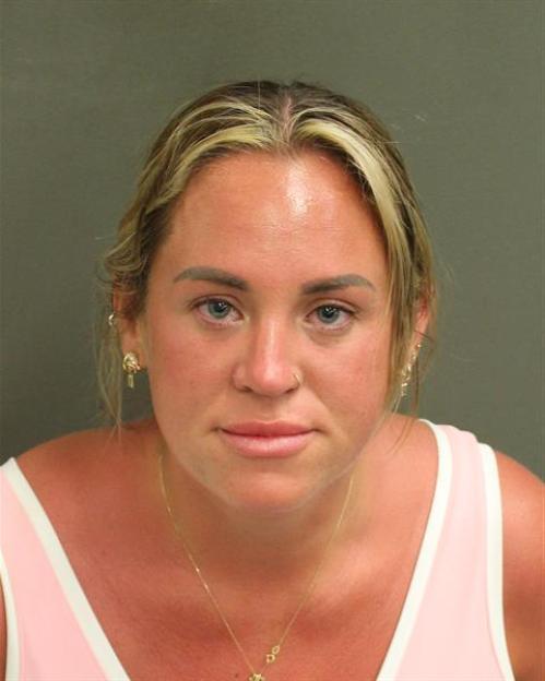 Mugshot of a woman, Flores's younger sister, charged with first-degree battery and second-degree disorderly conduct.
