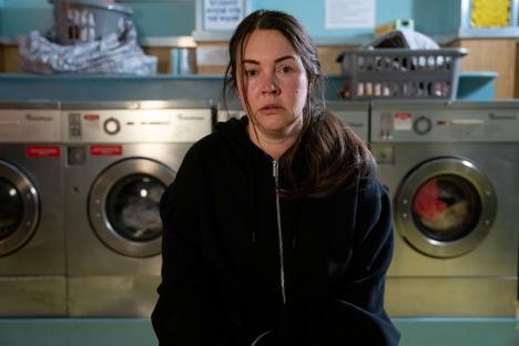 Stacey Slater from EastEnders in a laundromat.