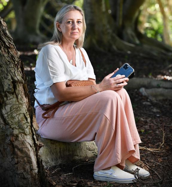 MAY 13, 2024: SUNSHINE COAST, QLD. Author Lauren Trevan, with a DV Safe Phone, poses during a photo shoot on the Sunshine Coast, Queensland. (Photo by Patrick Woods Photography / Newspix)