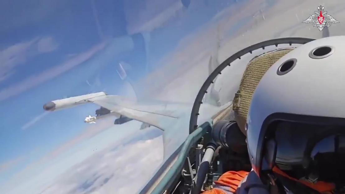 View from a Russian jet cockpit showing the wing of a Tu-95MS “Bear” Long-Range Strategic Bomber.