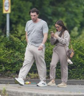 Jack Fincham and Chloe Brockett walking down the street.