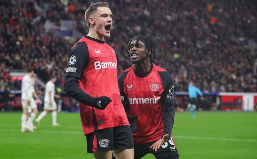 Two Bayer Leverkusen soccer players celebrating a goal.