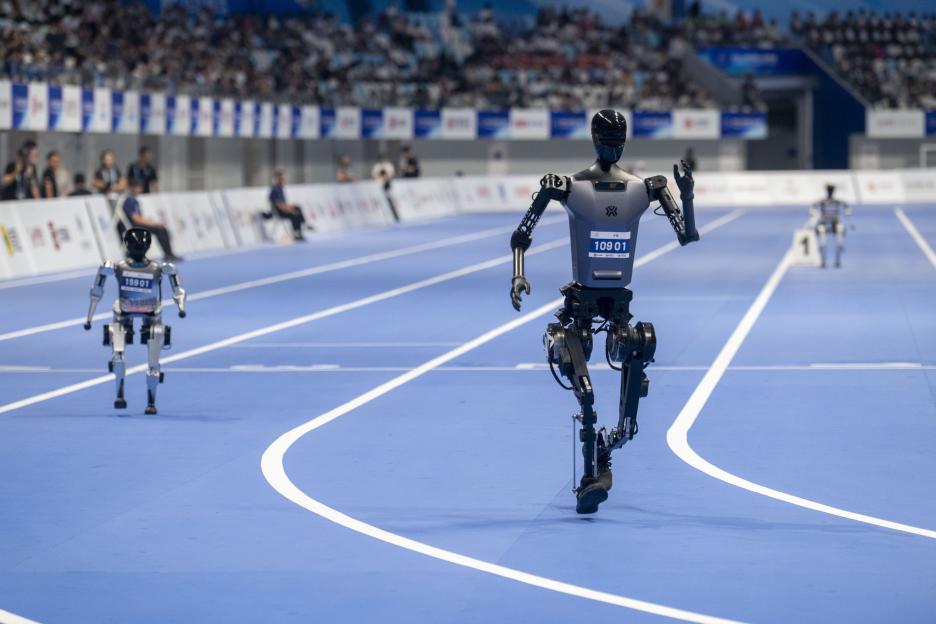 Humanoid robots competing in a 400m race.