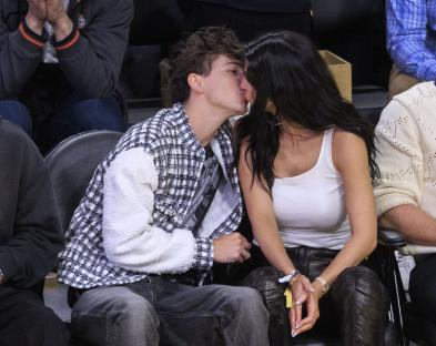 Timothée Chalamet and Kylie Jenner kissing at an NBA game.