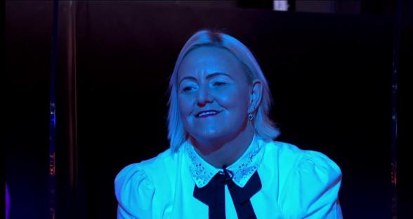Screenshot of a woman in a white shirt speaking.