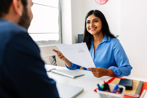 A woman reviewing a resume during a job interview.