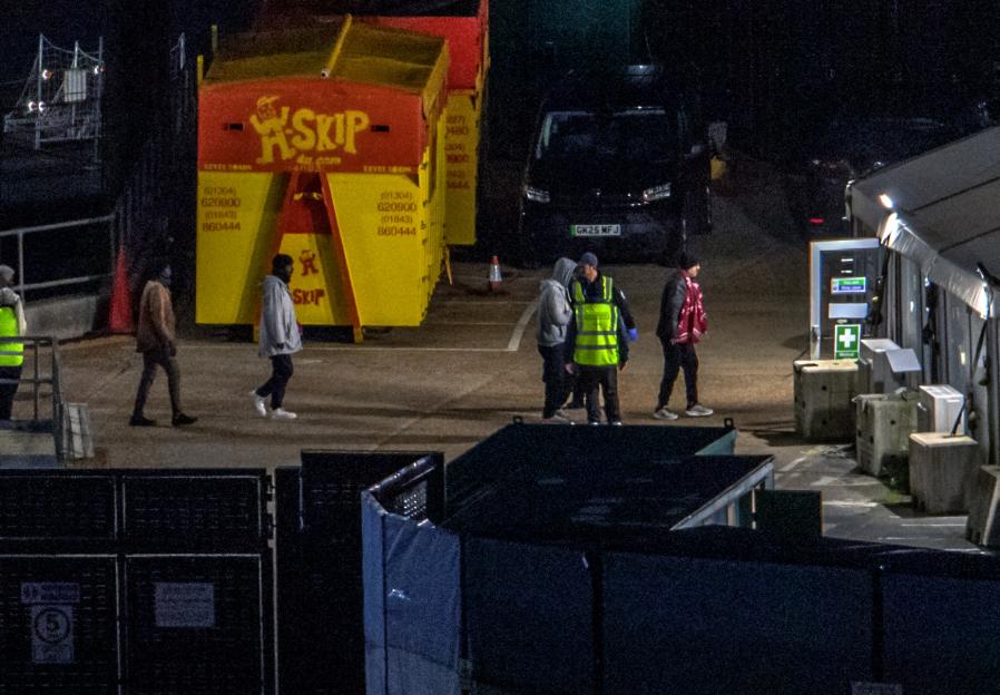 Border Force escorting migrants ashore at Dover Docks.